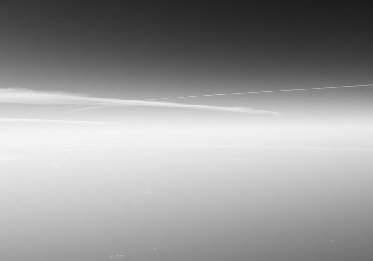 Empty sky with thin contrail